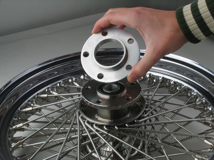 Bifunctional wheel hub flange offset spacer / centering collar extender by T.T.S.; for Rear sprocket / Pulley / Brake rotor; billet aluminum; hub centering collar Ø modification: 50→56 mm; outer Ø: 100 mm; offset: 5 mm; max. Ø of mounting bolts: 3/8”; gross weight: 110 g